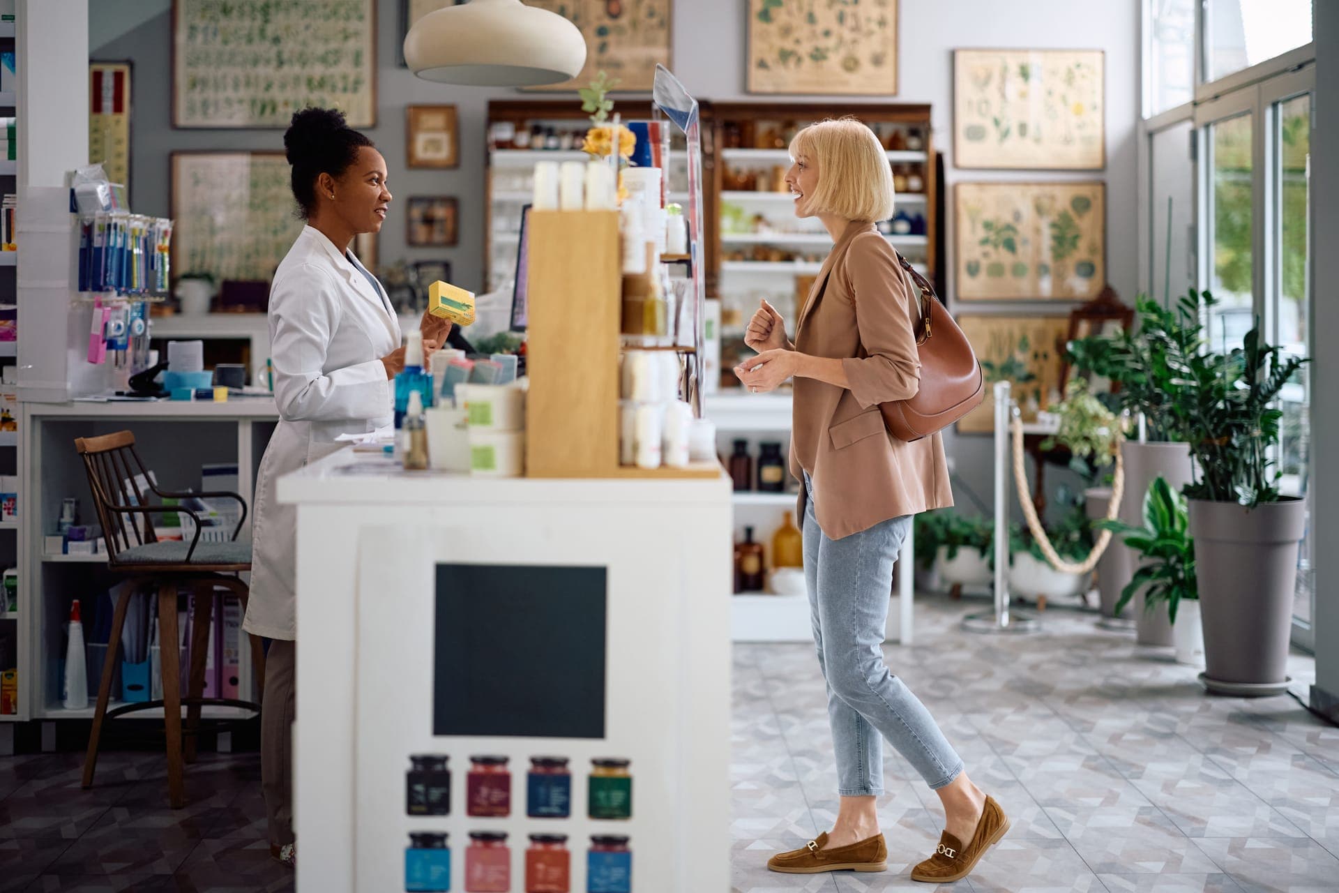 Pharmacist reviewing medication on a tablet in a pharmacy