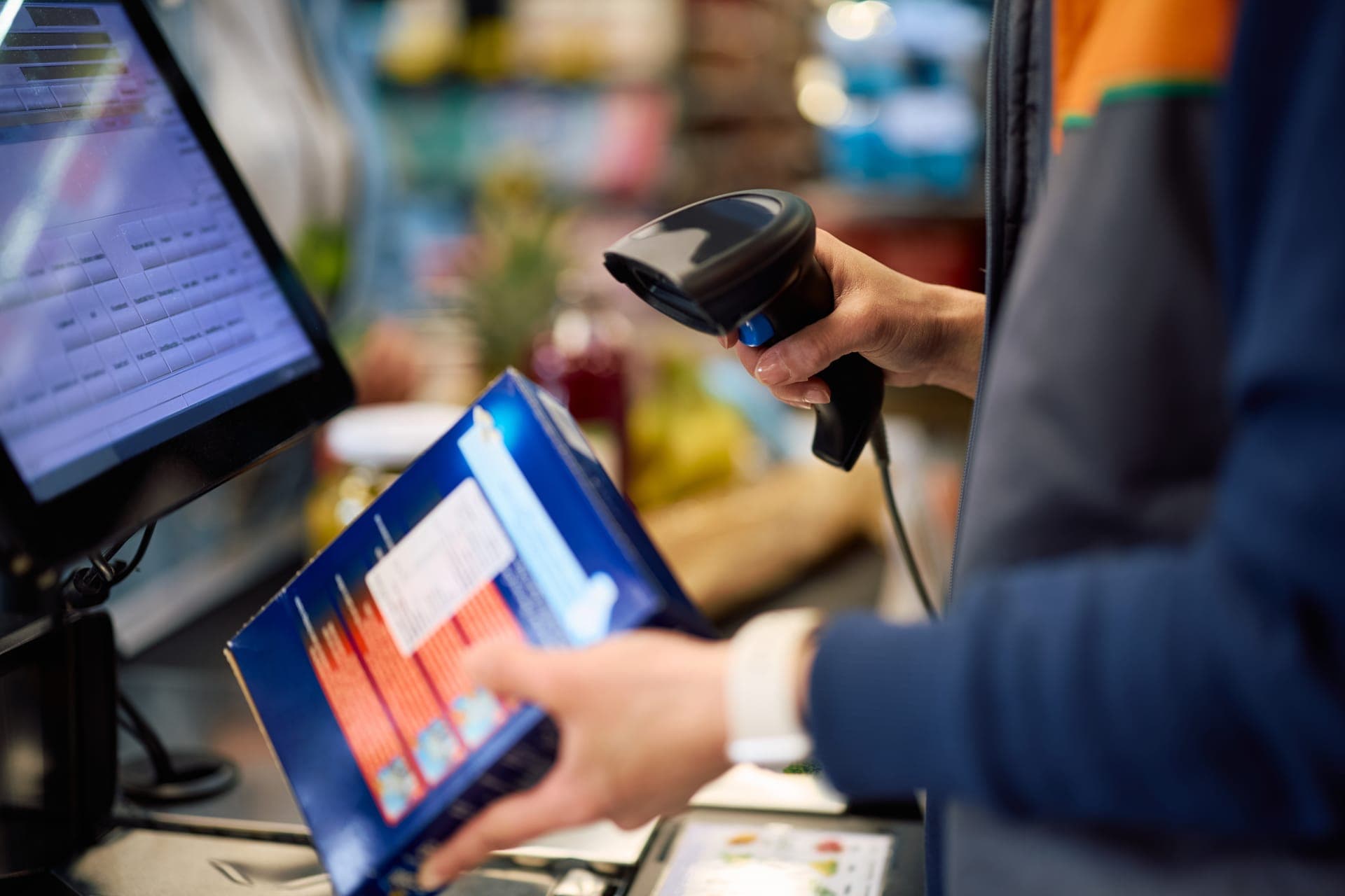 Shopping bags being handed to a customer at a bright retail counter