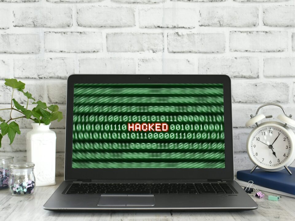 Laptop computer with a Hacked warning on the screen. Concept for hacker cyber attack danger
