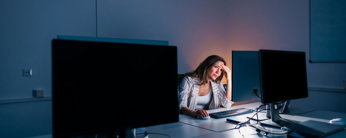 Woman anxious while working late in an office