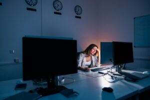 Woman anxious while working late in an office